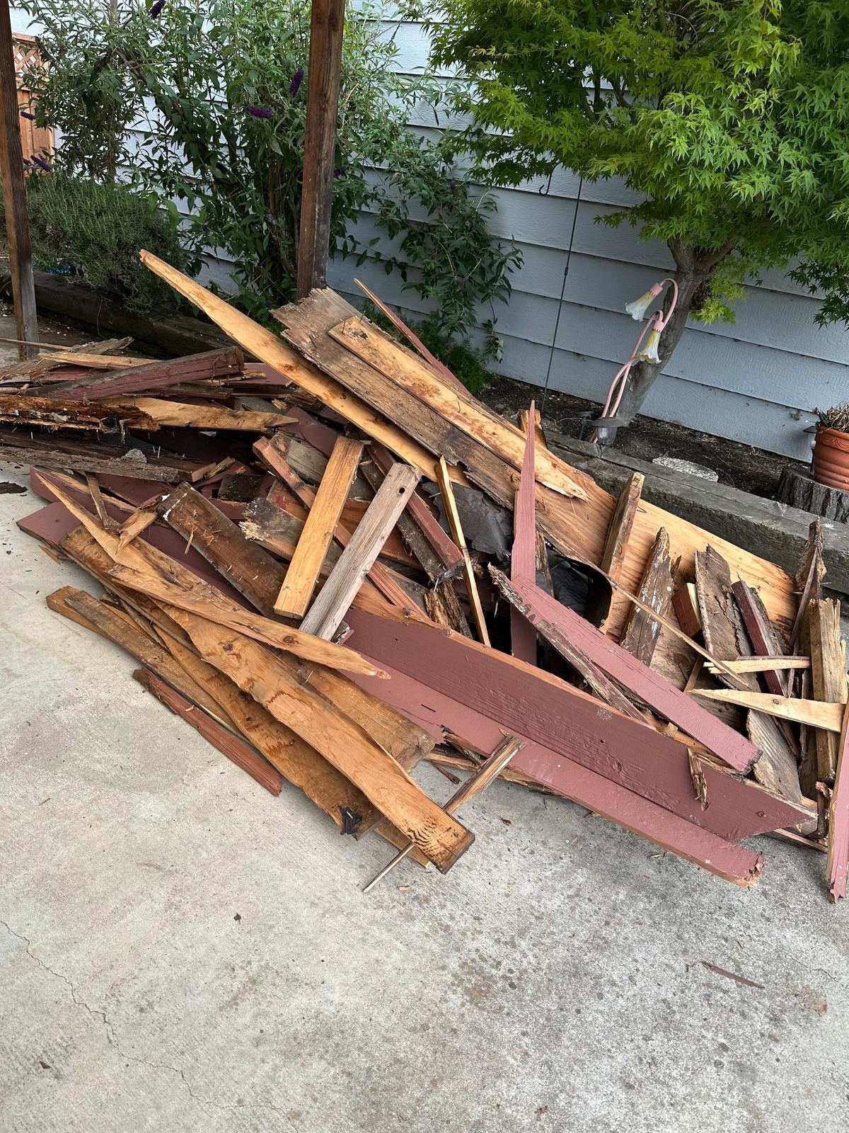 Wood planks and discarded building materials collected for removal