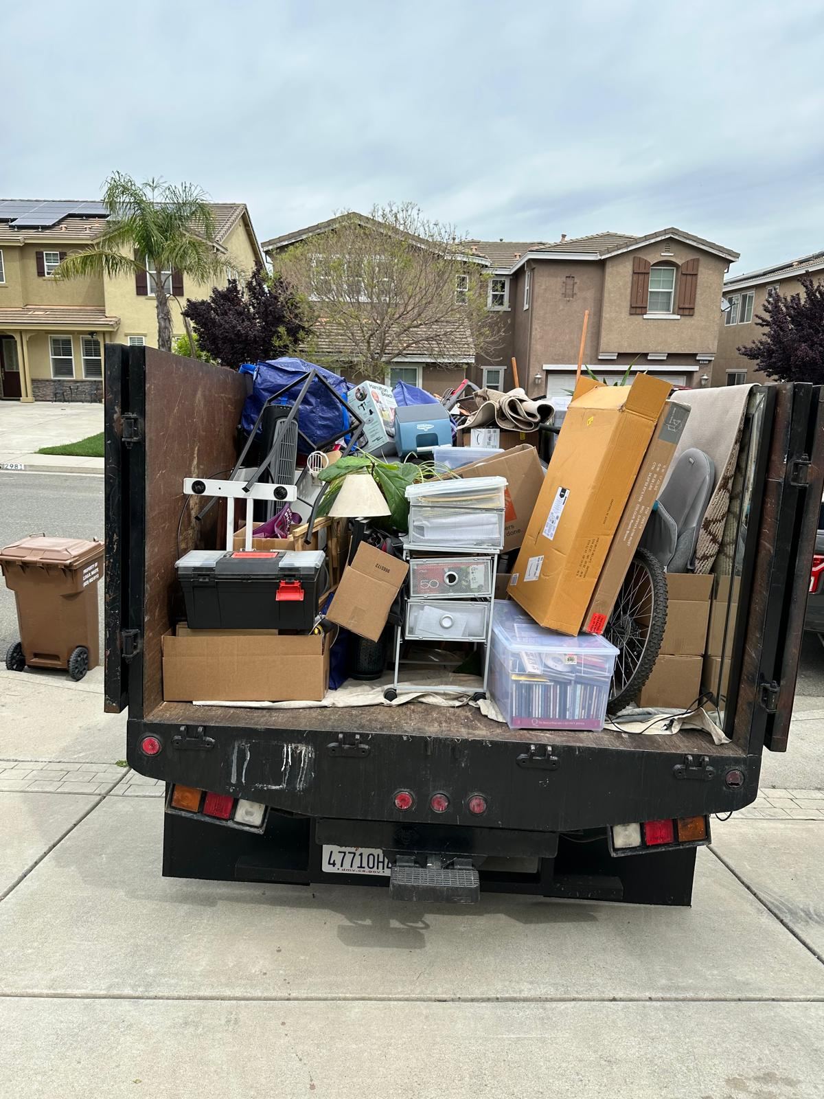 Dump truck loaded with unwanted household items for hauling