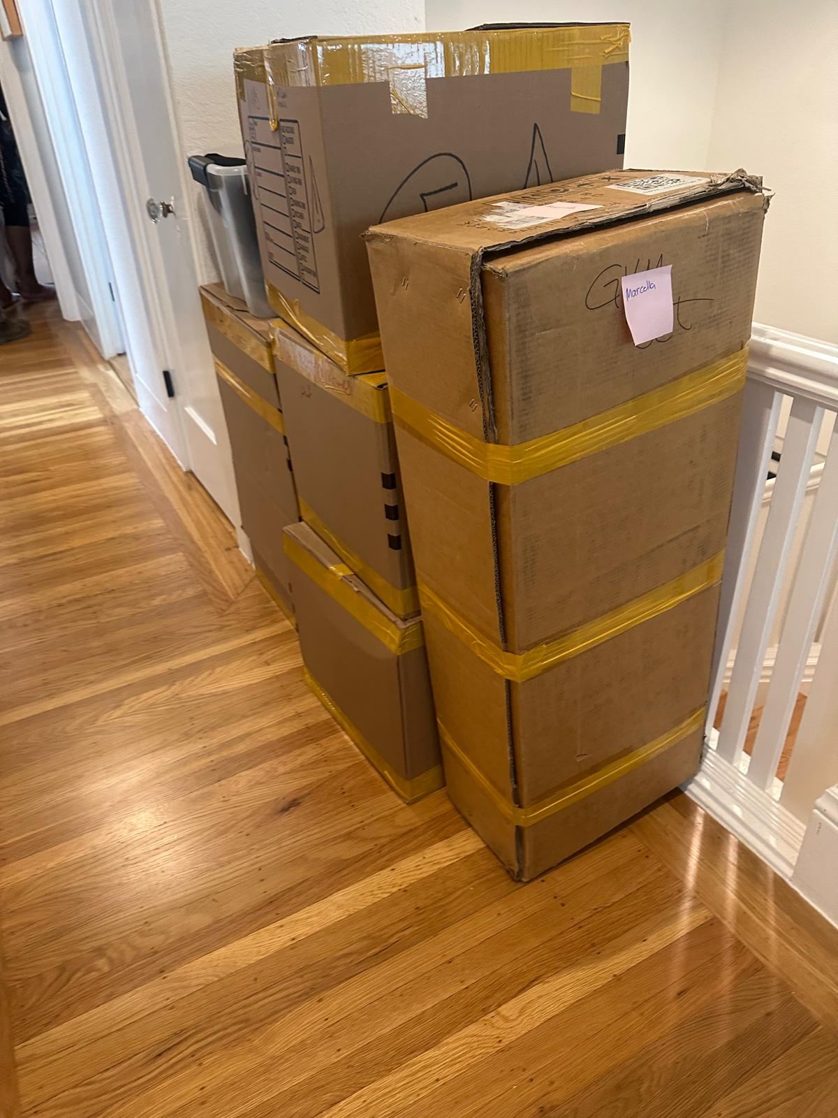 Packed boxes and household items in a residence before a move-out cleanout